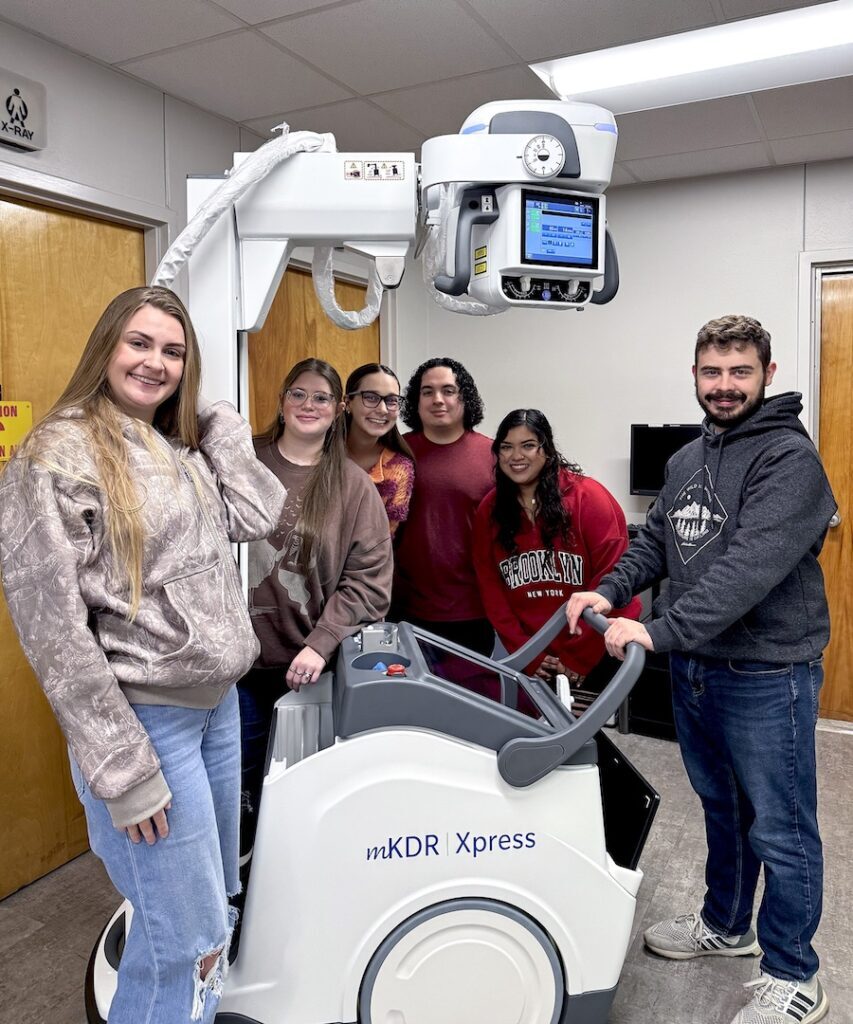 Students with Equipment (three photos):

Angelina College Radiologic Technology program students pose with the recently acquired Konica MKDR Express Portable X-Ray System. AC was able to purchase the new equipment thanks to funds from the Carl D. Perkins Basic Grant administered by the Texas Higher Education Coordinating Board. (Contributed photo)