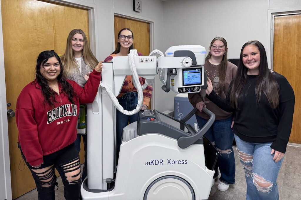 Students with Equipment (three photos):

Angelina College Radiologic Technology program students pose with the recently acquired Konica MKDR Express Portable X-Ray System. AC was able to purchase the new equipment thanks to funds from the Carl D. Perkins Basic Grant administered by the Texas Higher Education Coordinating Board. (Contributed photo)