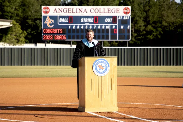 The college president speaking at an event