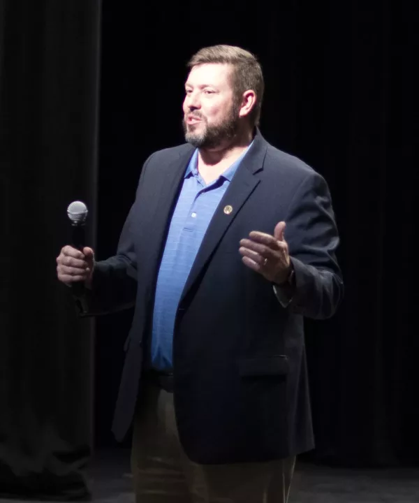 The college president speaking at an event