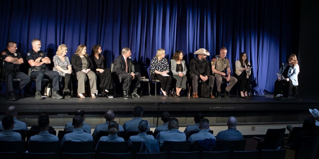 Criminal Justice Q&A panelists sit across a stage facing an audience in a campus auditorium.