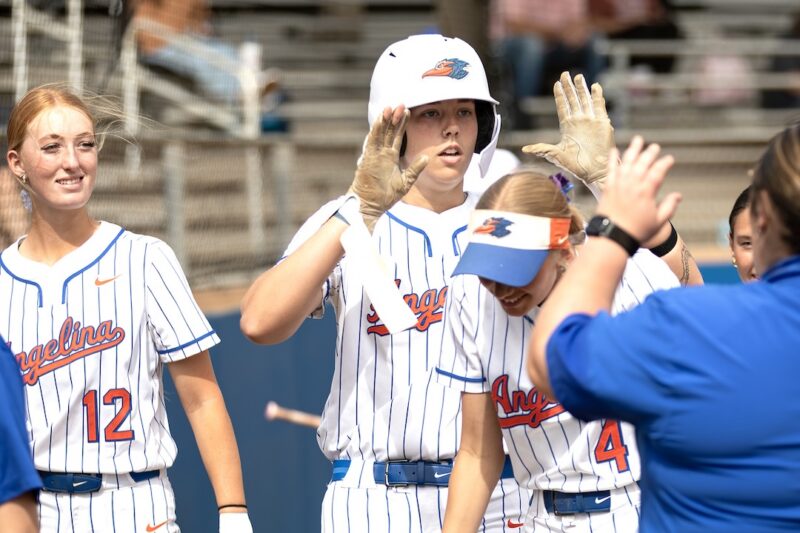 Angelina College softball player Breanne Calhoun celebrates with teammates after hitting a home run against Navarro.