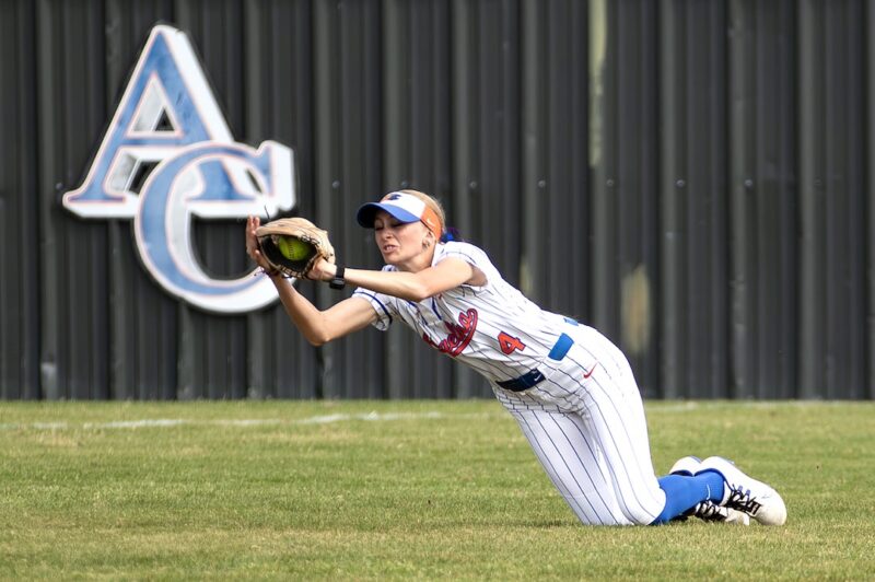 Angelina College softball player Elizabeth Craig dives forward in the outfield to make a catch against Navarro.