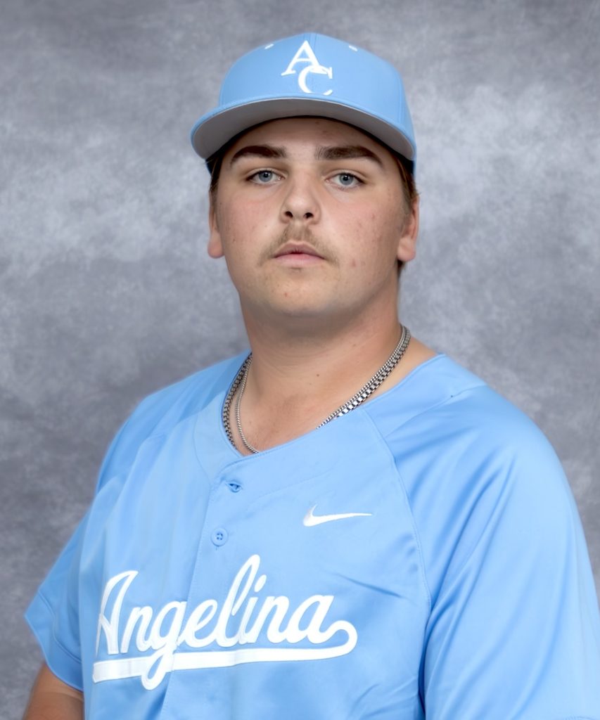 Young man in a light blue baseball uniform and cap labeled “Angelina,” standing before a gray studio backdrop.